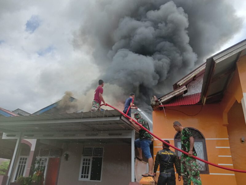 Satgas TMMD Ke 115 Kodim 0311/Pessel Bantu Padamkan Api  Rumah masyarakat yang terbakar.
