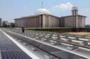 A technician inspects solar panels on the roof of Istiqlal grand mosque in Jakarta.<div class=